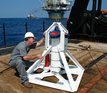 BMT staff member kneeling alongside monitoring equipment